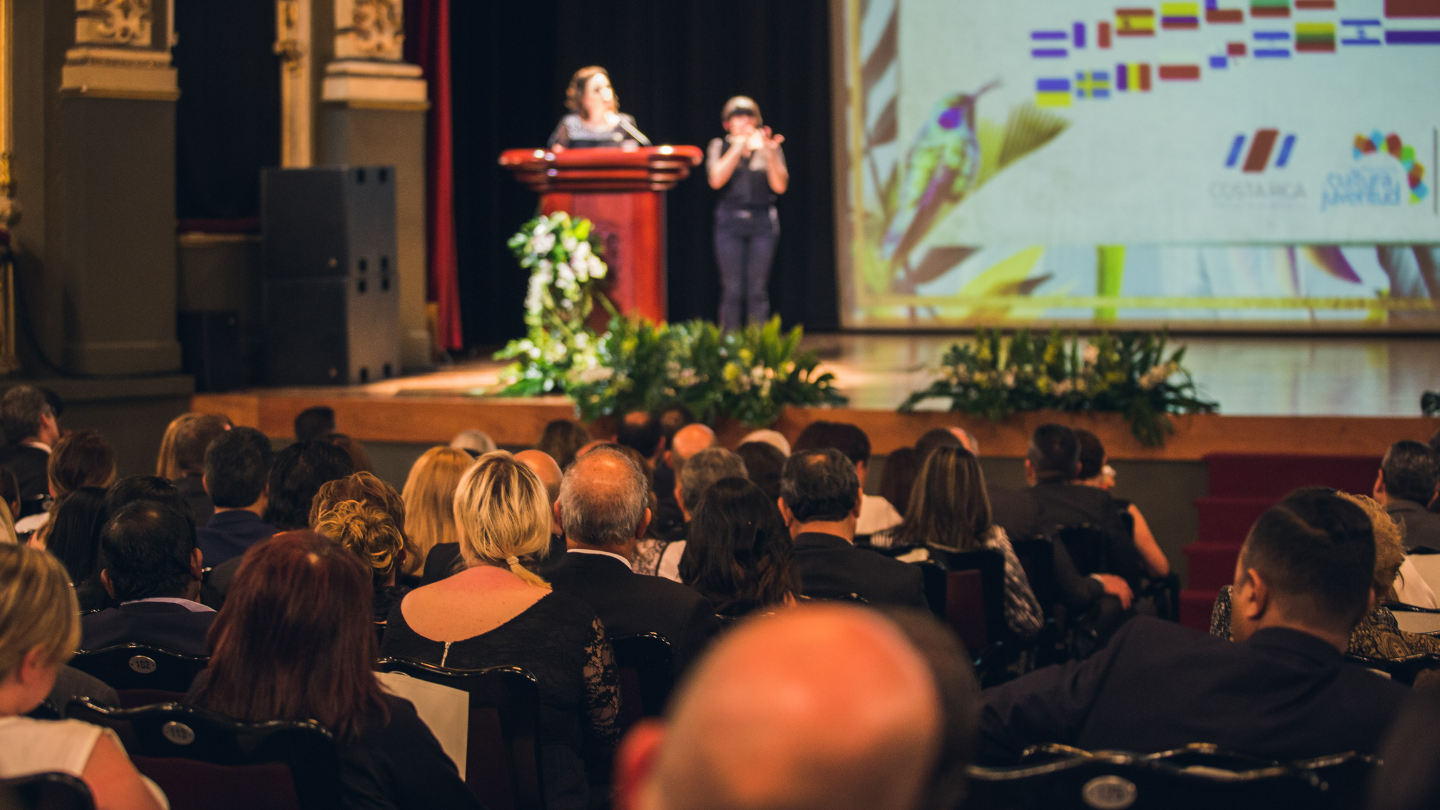 presenters onstage at an event in costa rica