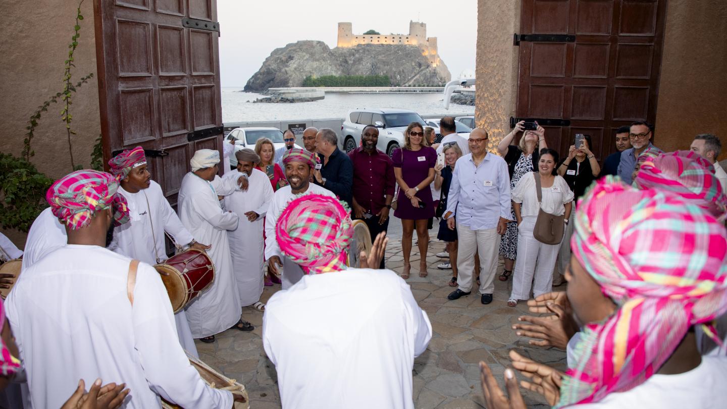 SITE group is welcomed by traditional Omani musicians at the entrance to a fort