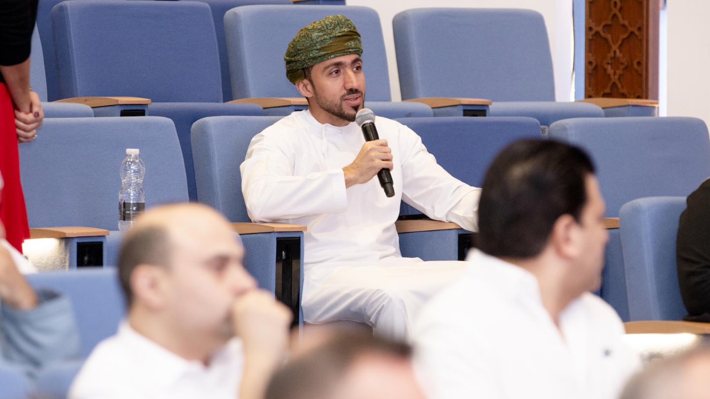 man speaking with a microphone during Exec Summit